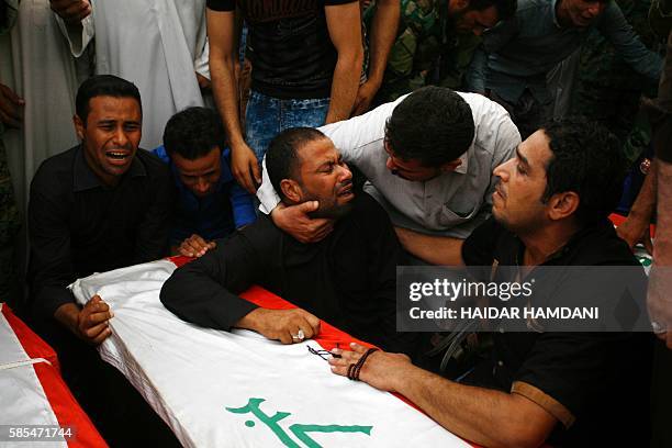 Iraqis mourn over the coffins of Shiite students who were killed in the Khalidiyah area of Iraq's Anbar province fighting alongside pro-government...