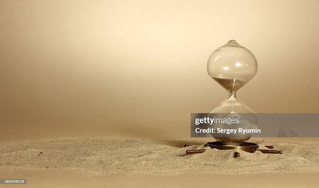 Hourglass on beige background