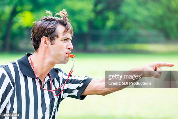 intense referee calls penalty during sporting event - árbitro imagens e fotografias de stock