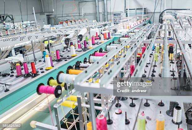 embroidery machine at a clothing factory - textiel stockfoto's en -beelden