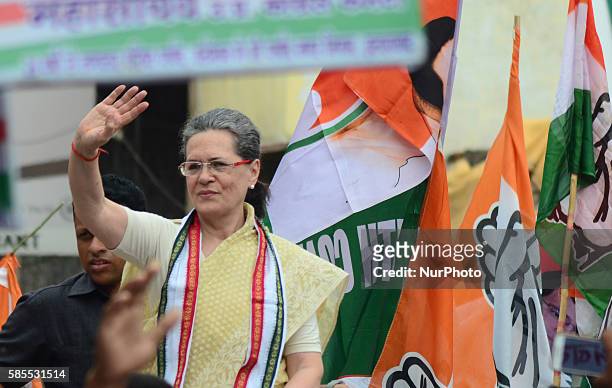 Congress Party's leader and president Sonia Gandhi waves hands towards supporters and local residents during her Road show in Varanasi on August...
