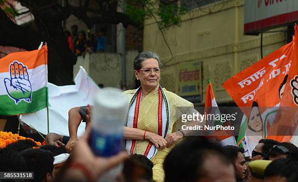 Congress Party's leader and president Sonia gandhi looks on towards supporters and local residents during her Road show in Varanasi on August...