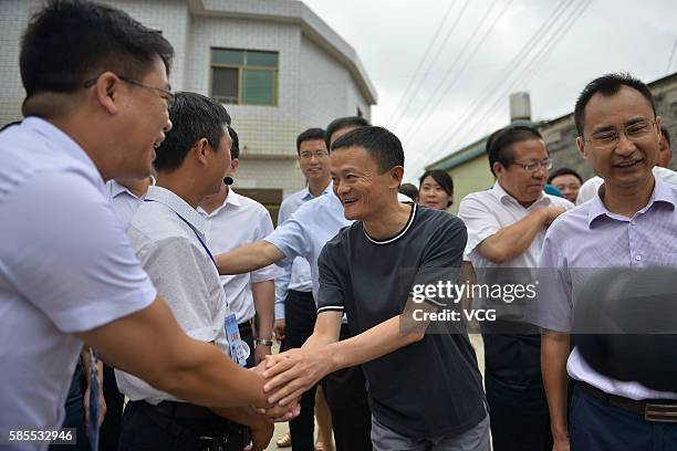 Alibaba Group Chairman Jack Ma shakes hands with rural teachers during the first training class of Jack Ma Foundation Rural Teachers Awards at...