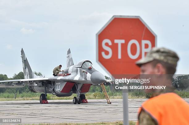 Technician prepares a Ukrainian MIG-29 fighter for its taking off prior to a practical flight during exercises at the Air Force military base in the...