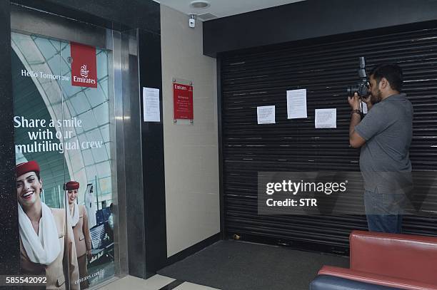 Photographer takes a picture of the closed Emirates airline office with notices confirming that flight EK521 travelling from Thiruvananthapuram to...