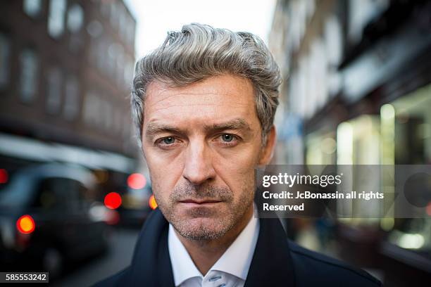 serious business man street portrait - jc bonassin ストックフォトと画像