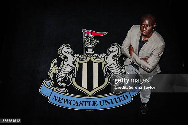 Mohamed Diame poses for a photograph with the club crest at St.James' Park on August 2 in Newcastle upon Tyne, England.