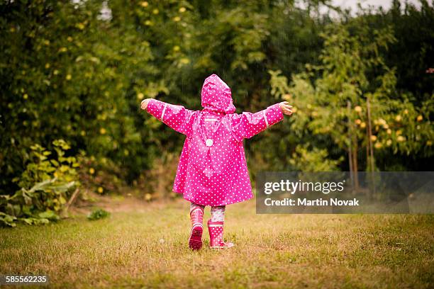 child catching rain - caught in rain stock pictures, royalty-free photos & images