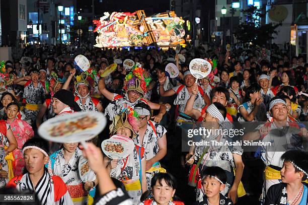 People marach on with 'Nebuta' floats as the Aomori Nebuta Festival begins on August 2, 2016 in Aomori, Japan.