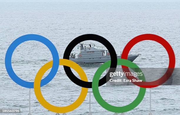 Security boat sails past the Olympic rings above the Arena de Vlei de Praia Beach Volleyball Venue during a training session on August 3, 2016 in Rio...