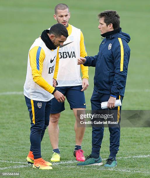 Carlos Tevez of Boca Juniors, Dario Benedetto of Boca Juniors and Guillermo Barros Schelotto coach talk during a Boca Juniors Training Session at...