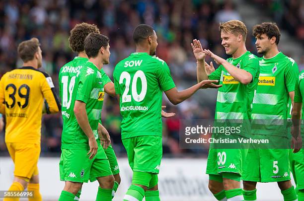 Djibril Sow of Borussia Moenchengladbach celebrates with his team mates after their first goal during a friendly match between KSV Hessen Kassel and...