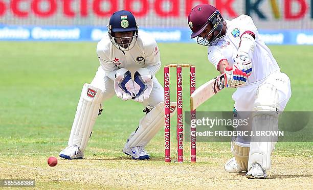 Shane Dowrich of the West Indies connects for a hit off a delivery from Mohammed Shami of India on day five of their Second Test cricket match on...