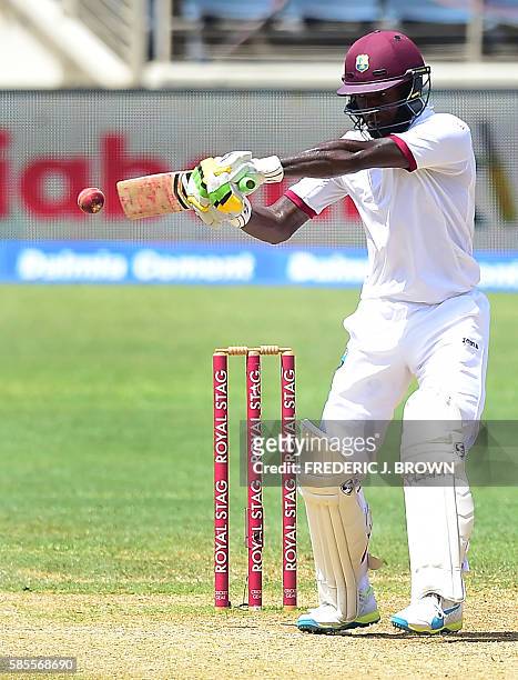 Jermaine Blackwood of the West Indies connects for a hit off a delivery from bowler Umesh Yadev of India on day five of their Second Test cricket...