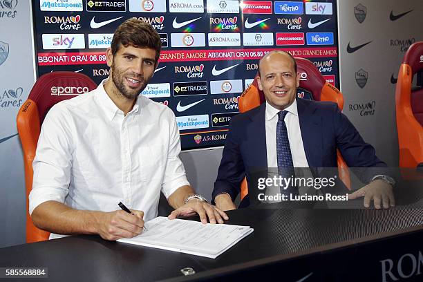 Roma new signing Federico Fazio signs his contract, watched by AS Roma General Manager Mauro Baldissoni at Centro Sportivo Fulvio Bernardini on...