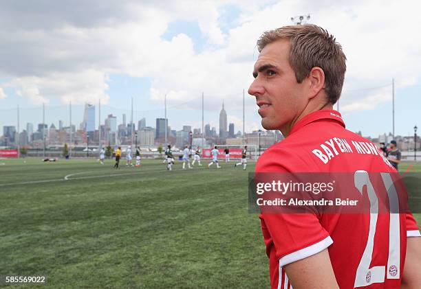 Philipp Lahm of FC Bayern Muenchen watches a soccer tournament played by FC Bayern Muenchen U.S. Fan clubs in front of New York's skyline during the...