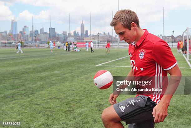 Philipp Lahm of FC Bayern Muenchen juggles a ball as he joins a soccer tournament played by FC Bayern Muenchen U.S. Fan clubs in front of New York's...