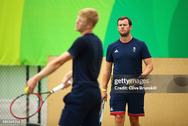 Team GB coach Leon Smith watches Kyle Edmund of Great Britain during a practice session ahead of the Rio 2016 Olympic Games at the Olympic Tennis...