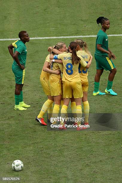 South Africa players look dejected as Nilla Fischer of Sweden celebrates with team mates as she scores their first goal during the Women's Group E...