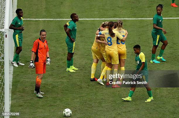 South Africa players look dejected as Nilla Fischer of Sweden celebrates with team mates as she scores their first goal during the Women's Group E...