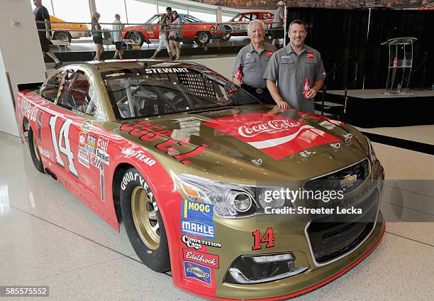 Bobby Allison and Tony Stewart pose for pictures with the car's new paint scheme during the No. 14 Darlington Throwback Announcement True Speed Press...