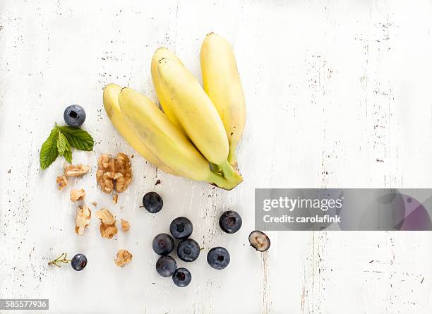 bananas with berries and nuts - blaubeeren stock pictures, royalty-free photos & images