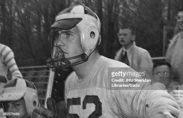Candid portrait of Johns Hopkins University freshman lacrosse midfielder Ed Rose sitting on the sidelines during a game, 1956. .