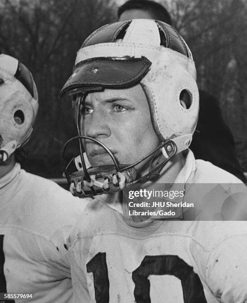 Candid portrait of Johns Hopkins University freshman lacrosse attackman Mickey Webster sitting on the sidelines during a game, 1956. .