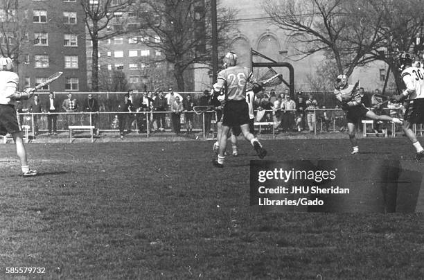 Players on a field during an N.C.A.A. Division one lacrosse game, in which one team was Johns Hopkins University, 1975. .