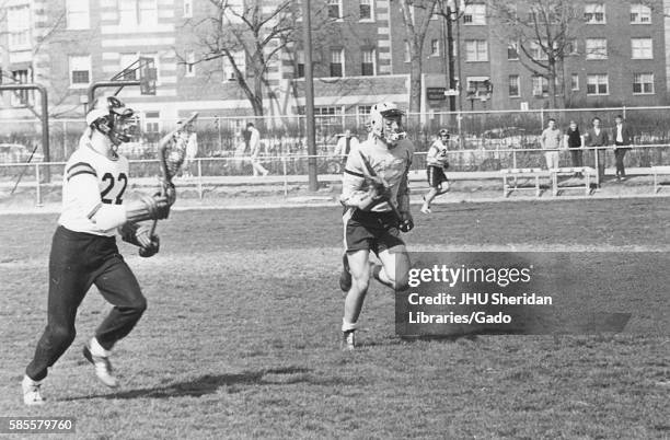 Players on a field during an N.C.A.A. Division one lacrosse game, in which one team was Johns Hopkins University, 1975. .