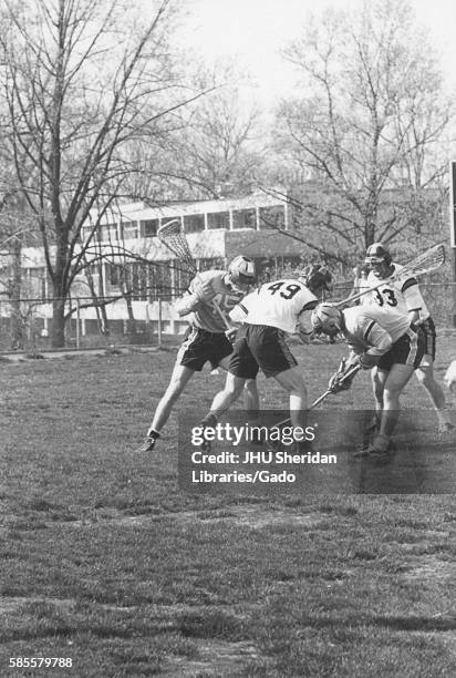 Players on a field during an N.C.A.A. Division one lacrosse game, in which one team was Johns Hopkins University, 1975. .