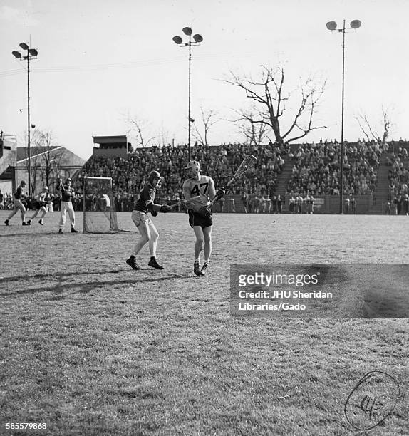 During a lacrosse game against Loyola, a Johns Hopkins Co-captain and attackman Byron Forbush is about to pass the ball, on the Homewood Field in...