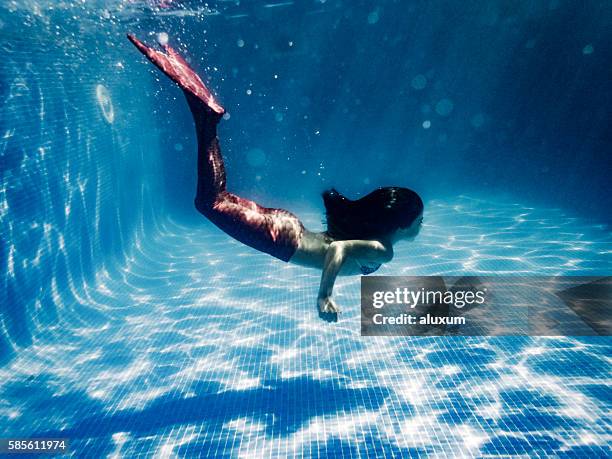 girl in mermaid costume diving in pool - mermaid stock pictures, royalty-free photos & images