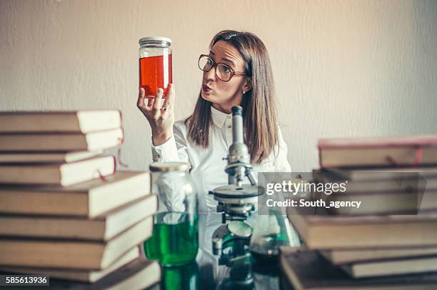 crazy woman chemist in lab - crazy professor stockfoto's en -beelden