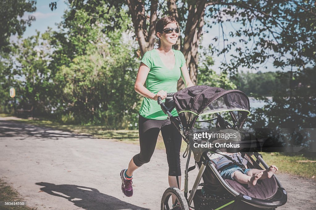 Mother Running Walking With baby Stroller in Park