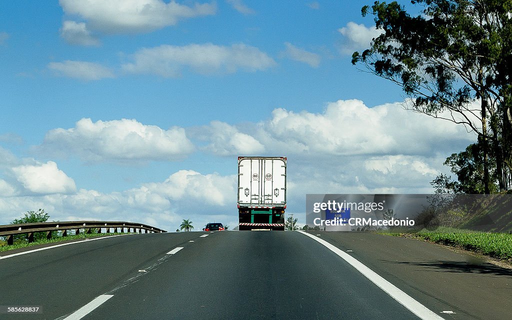 On the road under blue sky.