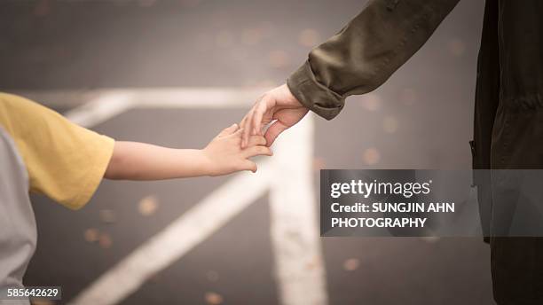 holding hands - sungjin ahn stock-fotos und bilder