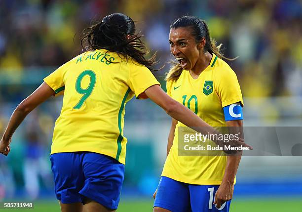 Marta of Brazil celebrates with Andressa Alves as she scores their second goal during the Women's Group E first round match between Brazil and China...