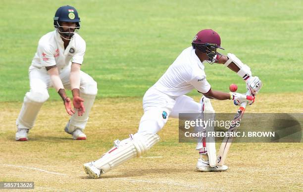 Shane Dowrich of the West Indies is bowled out an an LBW from bowler Amit Mishra of India as Cheteshwar Pujara gets close on day five of their Second...