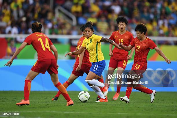 Cristiane of Brazil takes on Rong Zhao , Dongna Li , Rui Zhang and Fengyue Pang of China during the Women's Group E first round match between Brazil...