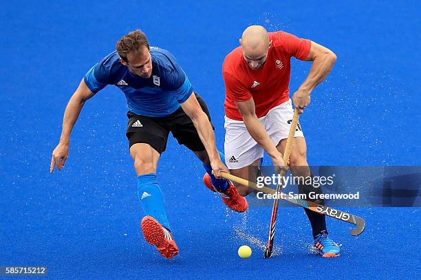 Nick Catlin of Great Britain attempts to run past Facundo Callioni of Argentina during a training session in the Olympic Hockey Center on August 3,...