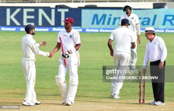 India's captain Virat Kohli and Roston Chase of the West Indies congratulate one another at the end of their match on day five of their Second Test...