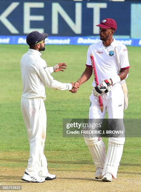 India's captain Virat Kohli and Roston Chase of the West Indies congratulate one another at the end of their match on day five of their Second Test...