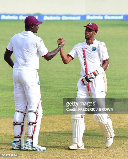 West Indies batsmen Jason Holder and Roston Chase congratulate one another at the end of their match on day five of their Second Test cricket match...