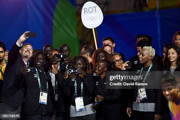 Olympic Refugee Team athletes for the Rio 2016 Olympic Games attend their welcome ceremony at the Athletes village on August 3, 2016 in Rio de...