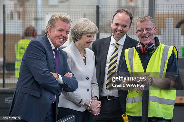 British Prime Minister Theresa May, Martek Managing Director Derek Galloway and Croydon Central MP Gavin Barwell speak with a worker as they visit...