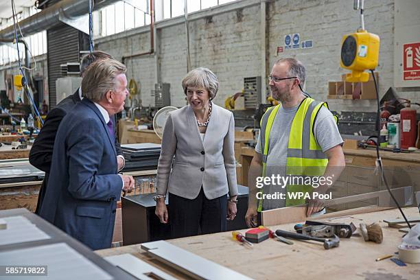 British Prime Minister Theresa May, Martek Managing Director Derek Galloway and Croydon Central MP Gavin Barwell speak with a worker as they visit...