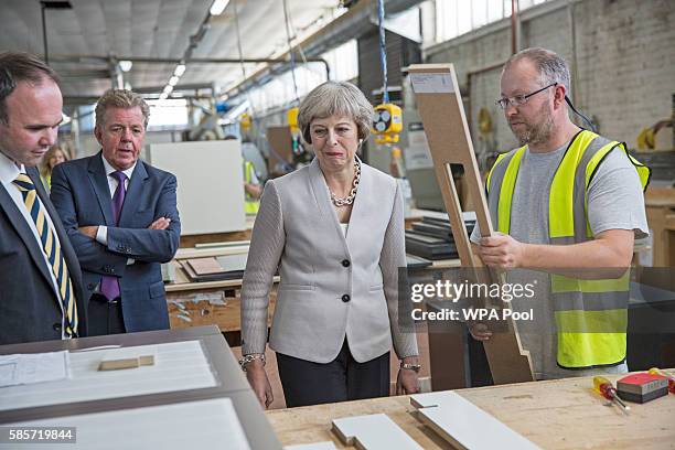 British Prime Minister Theresa May, Martek Managing Director Derek Galloway and Croydon Central MP Gavin Barwell speak with a worker as they visit...