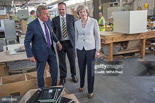 British Prime Minister Theresa May walks with Martek Managing Director Derek Galloway and Croydon Central MP Gavin Barwell during a visit to Martinek...