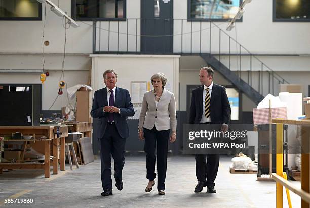 British Prime Minister Theresa May walks with Martek Managing Director Derek Galloway and Croydon Central MP Gavin Barwell during a visit to Martinek...